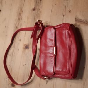 Red bag with gold clasp. No brand. Used but good condition.